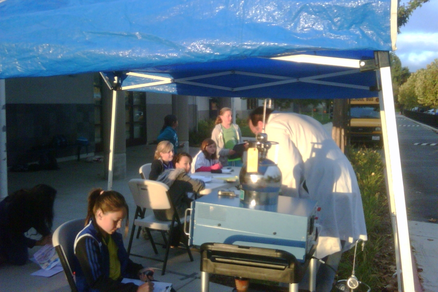 Brian Buller under a tent with students