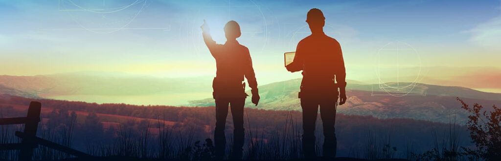 Silhouette of two environmental engineers in the outdoors