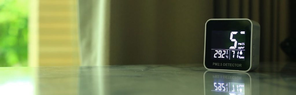 An indoor air quality reader sits on an office counter