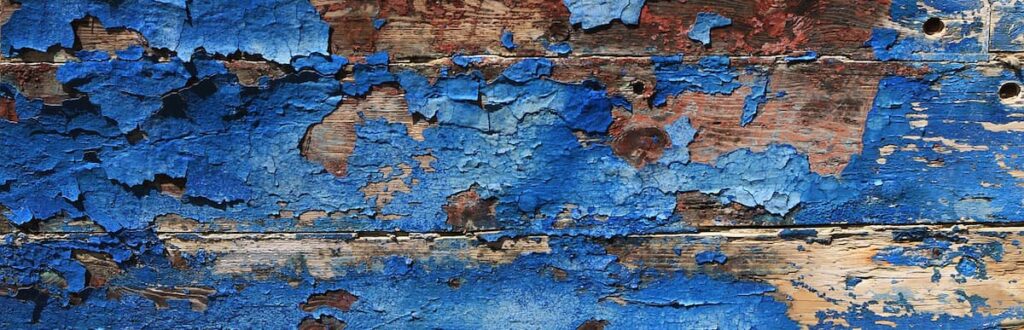 Close up image of old, peeling paint on a wooden wall