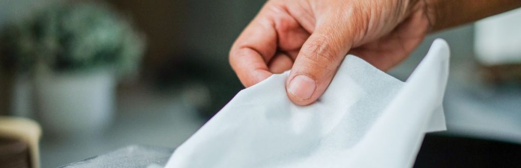 Close up of hand pulling tissue.