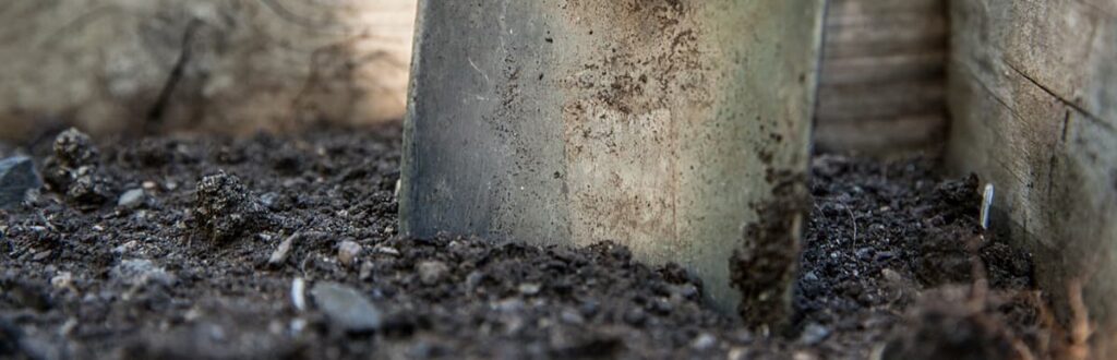 Close up image of trowel and soil