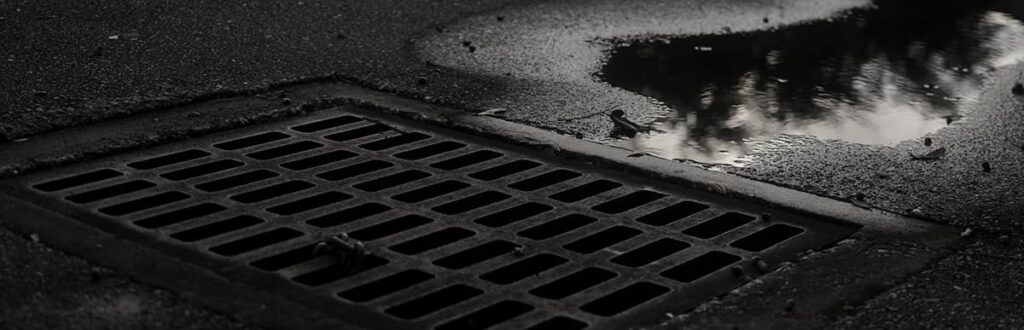 A puddle and street drain