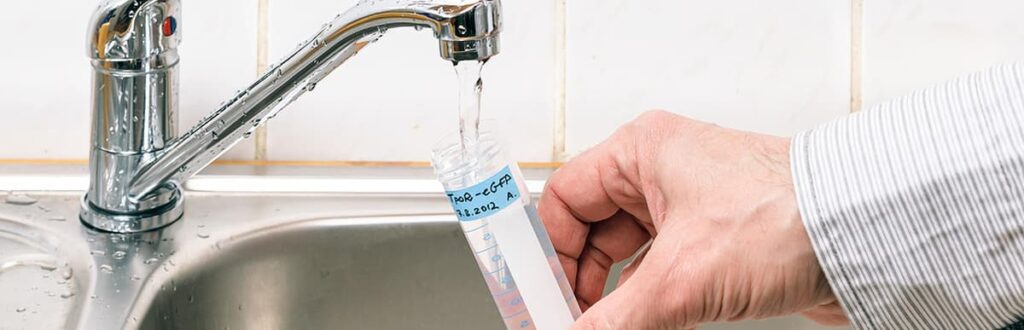 Filling a water sample container from an indoor faucet