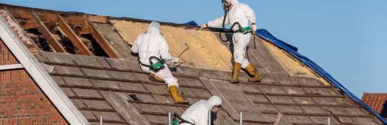 Professionals removing asbestos from a roof.