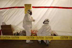 Workers in hazmat suits